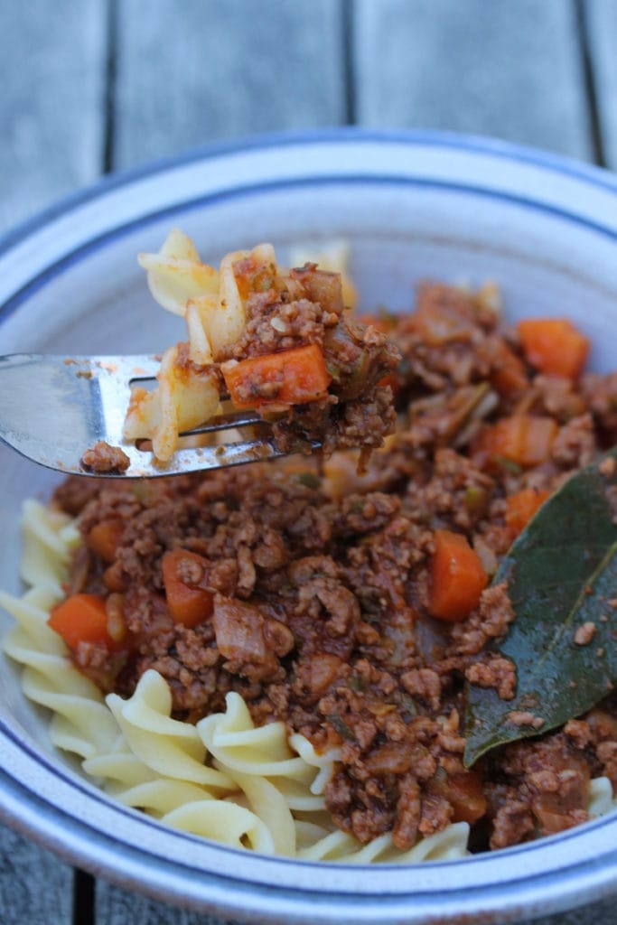 Pasta bolognese served in a bowl with a bay leaf on top #glutenfreedinner #coeliacfood