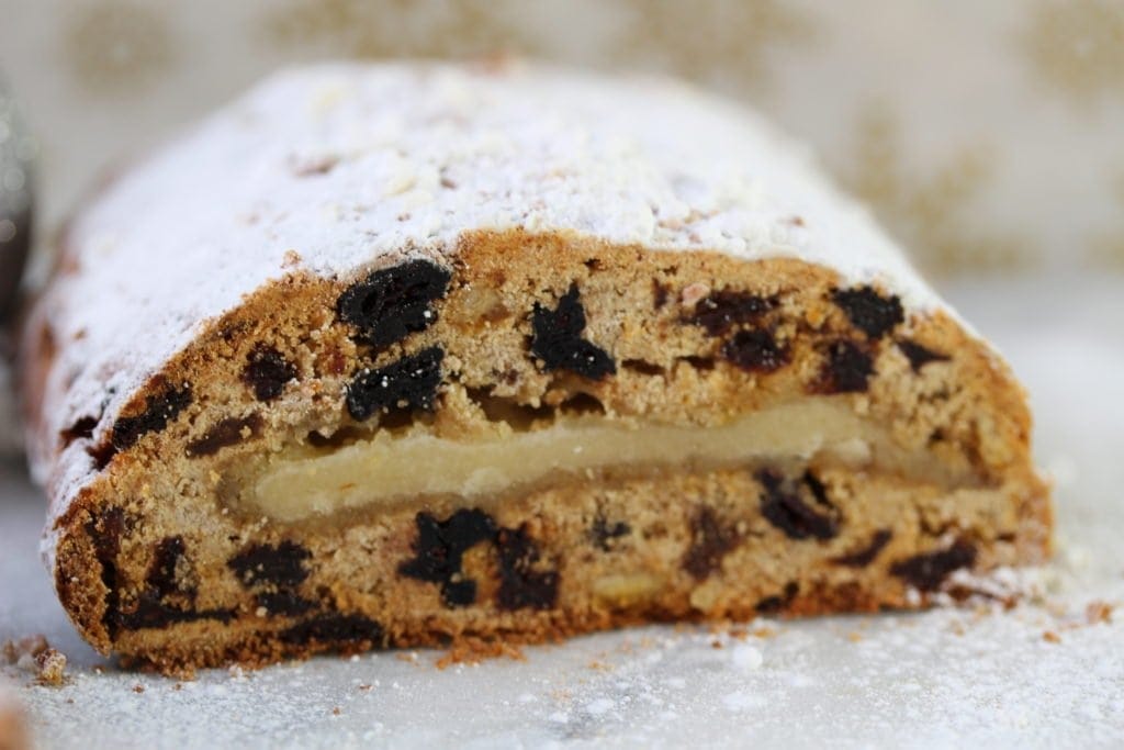 A close up of the cut end of the stollen loaf showing that it is packed with fruit and the middle marzipan layer. 