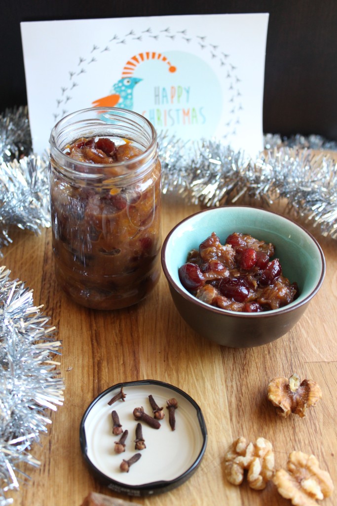 Low fodmap mincemeat in a jar and bowl with some nuts and cloves in the foreground