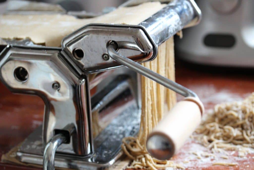 Passing pasta dough through a pasta machine