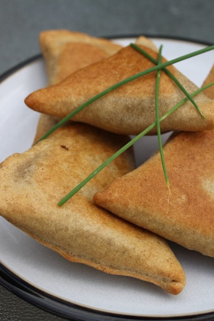 Gluten free samosas close up view with chives on top