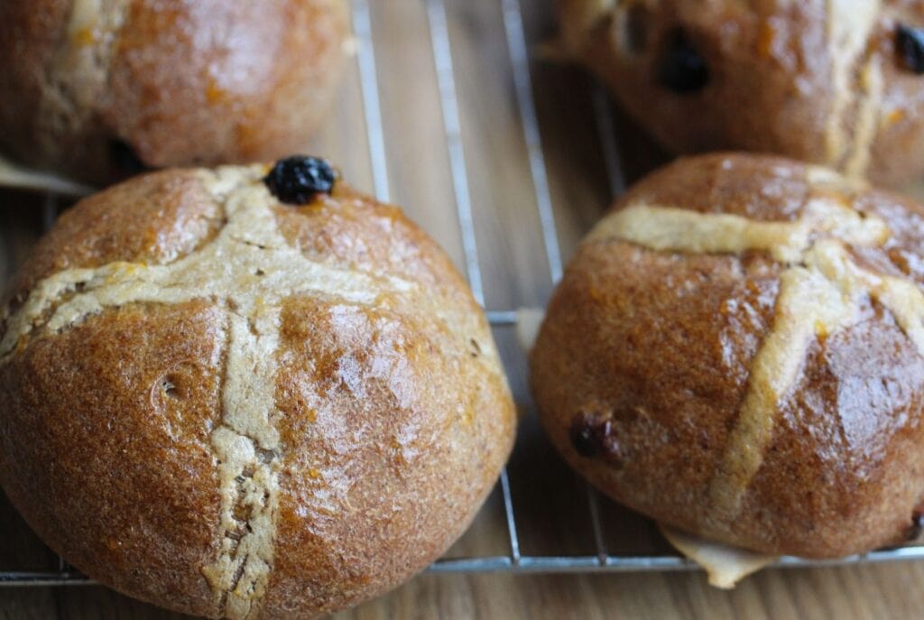 Gluten free hot cross buns cooling on a wire rack