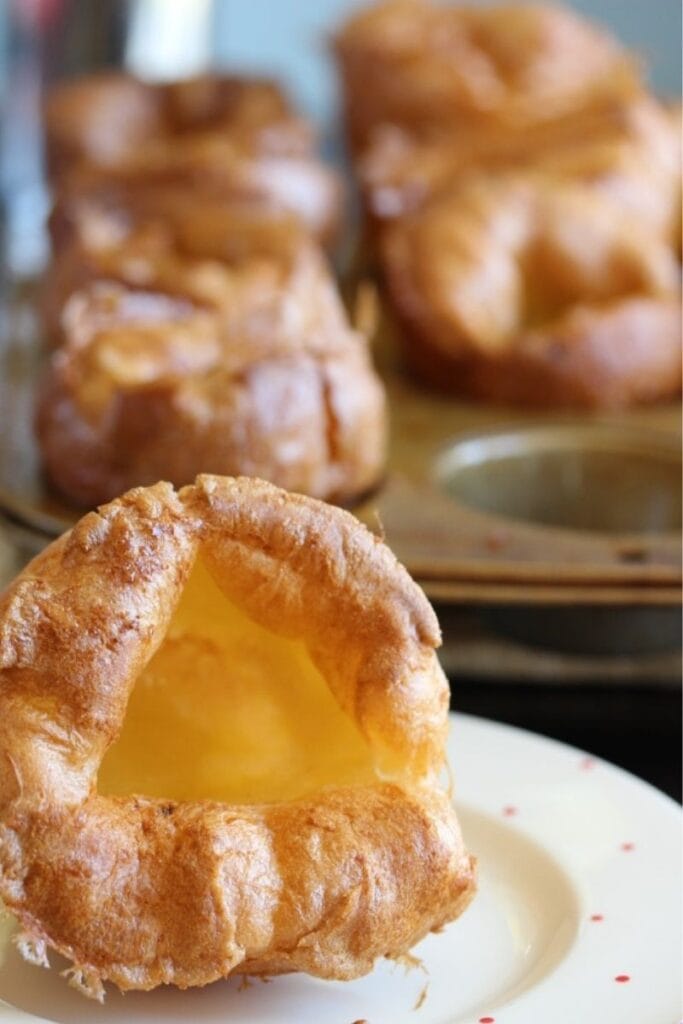 Gluten free Yorkshire puddings. One large one in the foreground with the rest still in the tin behind.