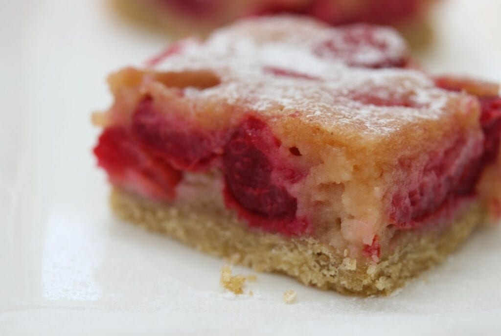 A slice of gluten free cherry pie on a white plate