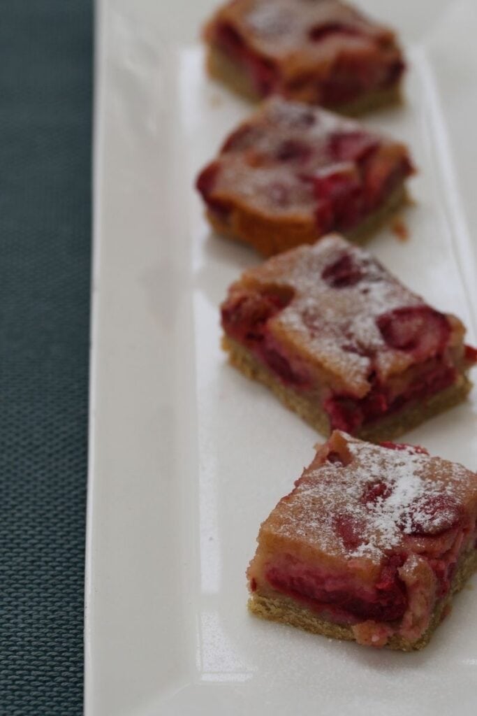 Slices of gluten free cherry pie on a white rectangular plate