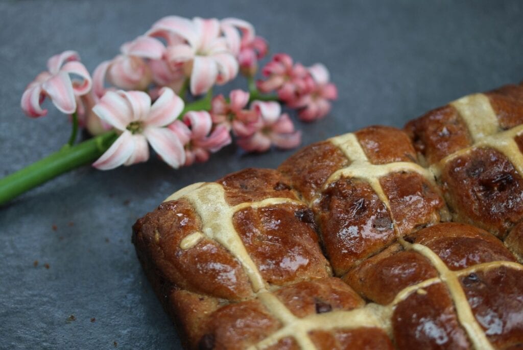 Salted caramel hot cross buns with a spring hyacinth.